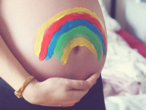 Maternity/Pregnancy shot showing a colorful painted baby bump.